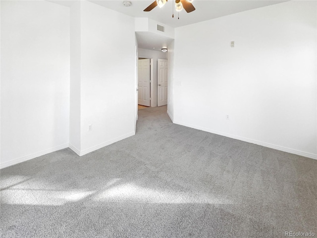 spare room featuring ceiling fan and carpet floors