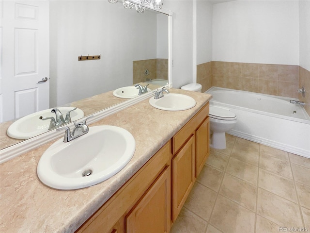 bathroom with tile patterned floors, toilet, vanity, and a washtub