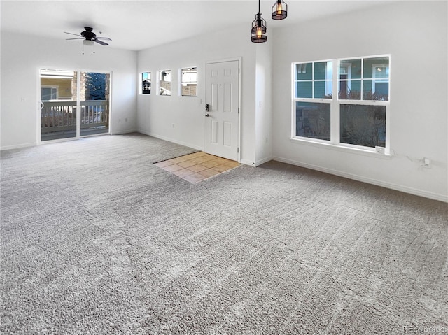 carpeted entryway featuring ceiling fan