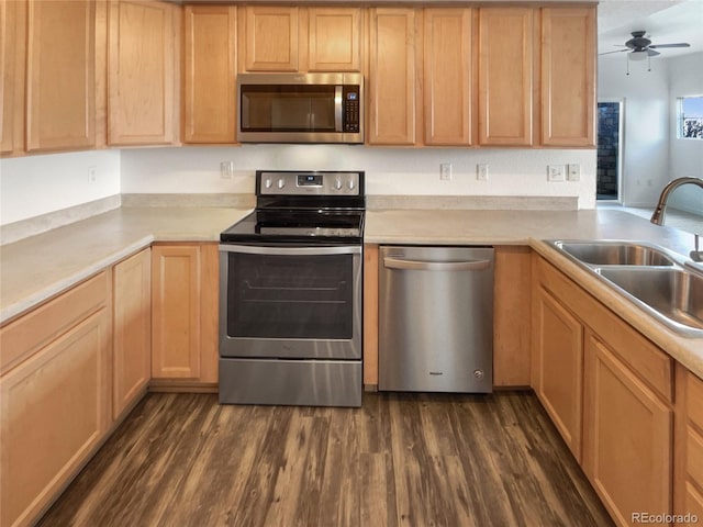 kitchen with sink, ceiling fan, appliances with stainless steel finishes, dark hardwood / wood-style floors, and light brown cabinetry