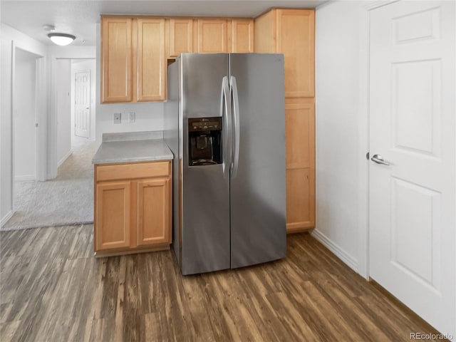 kitchen with dark hardwood / wood-style flooring, stainless steel fridge with ice dispenser, and light brown cabinets