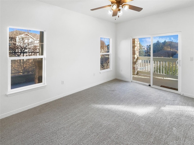 carpeted empty room featuring ceiling fan