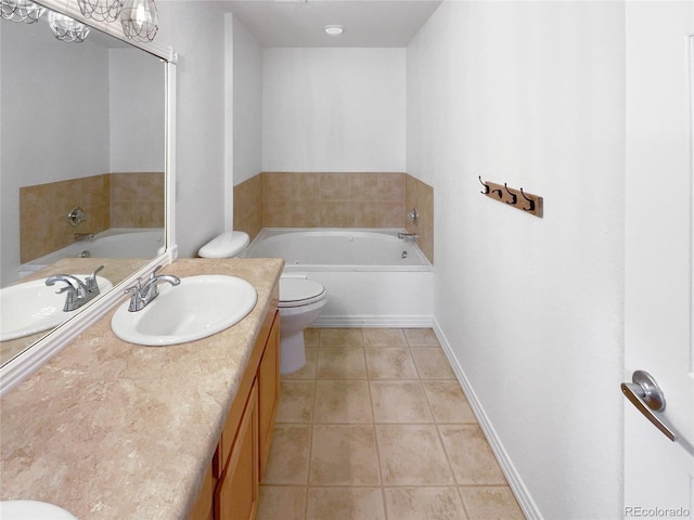 bathroom with tile patterned flooring, vanity, a bath, and toilet