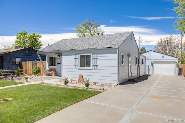 935 Newark St, Aurora, CO 80010 - view of front of property featuring a shingled roof, an outdoor structure, a garage, and driveway