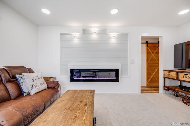 935 Newark St, Aurora, CO 80010 - living room with a glass covered fireplace, carpet, recessed lighting, and a barn door