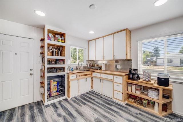 935 Newark St, Aurora, CO 80010 - kitchen featuring wooden counters, a sink, light wood-style flooring, backsplash, and recessed lighting