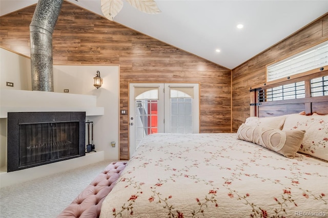 935 Newark St, Aurora, CO 80010 - bedroom with wood walls, vaulted ceiling, access to outside, a fireplace, and carpet