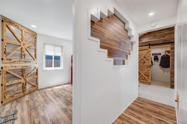 935 Newark St, Aurora, CO 80010 - corridor with a barn door, wood finished floors, and recessed lighting