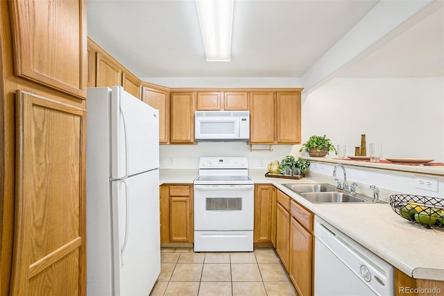 kitchen featuring sink, light tile patterned floors, and white appliances