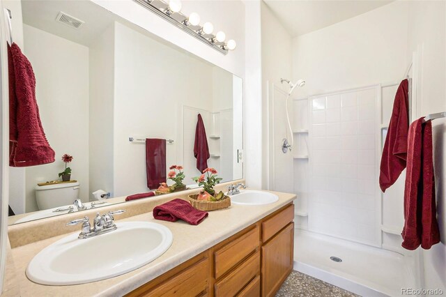 bathroom featuring vanity, toilet, and walk in shower