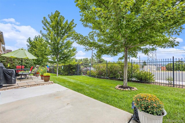 view of yard featuring a water view and a patio area