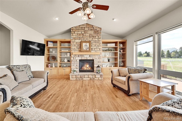 19045 Shiloh Ranch Dr, Colorado Springs, CO 80908 - living area featuring ceiling fan, light wood finished floors, lofted ceiling, a stone fireplace, and recessed lighting