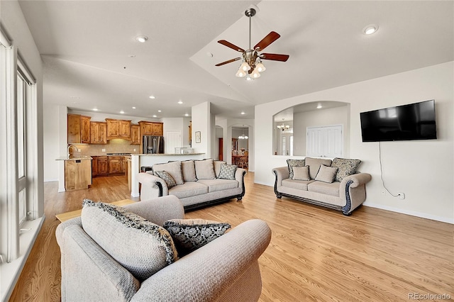19045 Shiloh Ranch Dr, Colorado Springs, CO 80908 - living room with arched walkways, ceiling fan, recessed lighting, vaulted ceiling, and light wood-style flooring