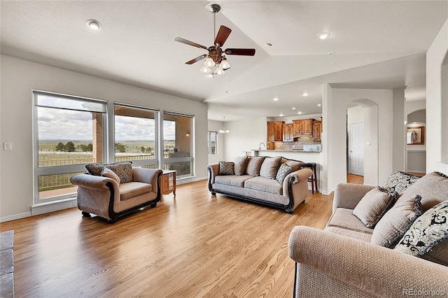 19045 Shiloh Ranch Dr, Colorado Springs, CO 80908 - living area featuring arched walkways, lofted ceiling, a ceiling fan, light wood finished floors, and recessed lighting