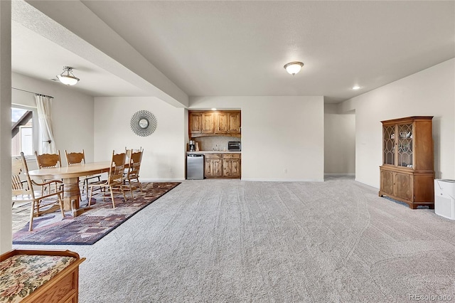19045 Shiloh Ranch Dr, Colorado Springs, CO 80908 - living room with light colored carpet, baseboards, and bar