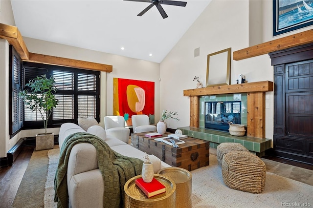 living room featuring visible vents, a tiled fireplace, wood finished floors, high vaulted ceiling, and recessed lighting