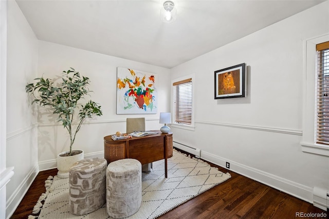 office space with dark wood-style flooring, baseboard heating, a baseboard radiator, and baseboards