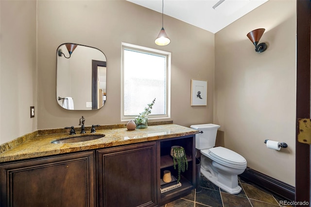 half bath with vanity, toilet, and tile patterned floors