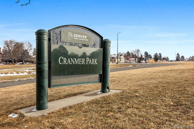 community / neighborhood sign with a yard