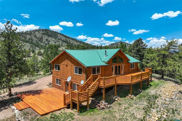 70 Elk Cir, Guffey, CO 80820 - rear view of house with a deck with mountain view, stairs, a view of trees, and a metal roof