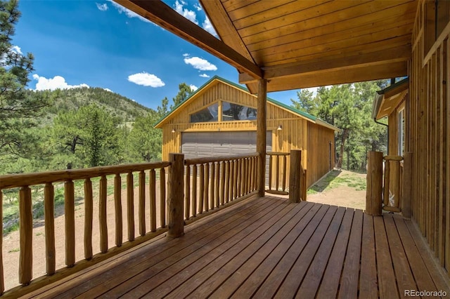 70 Elk Cir, Guffey, CO 80820 - wooden terrace featuring a mountain view, a garage, and an outbuilding