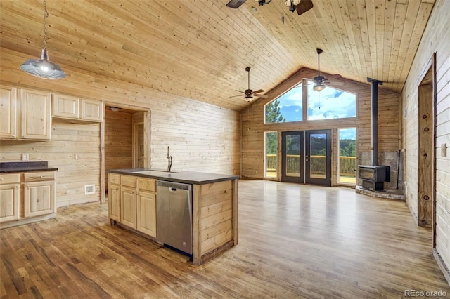 70 Elk Cir, Guffey, CO 80820 - kitchen with stainless steel dishwasher, ceiling fan, dark countertops, wood walls, and light brown cabinetry