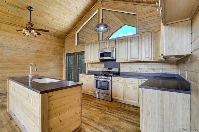 70 Elk Cir, Guffey, CO 80820 - kitchen featuring stainless steel appliances, dark countertops, wooden walls, wooden ceiling, and light wood-type flooring