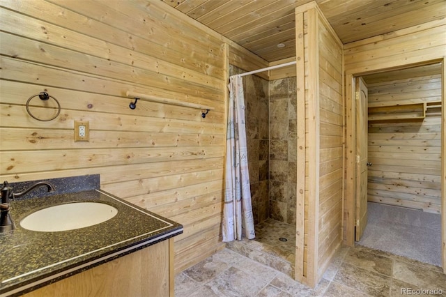 70 Elk Cir, Guffey, CO 80820 - full bath with wood walls, wood ceiling, a shower stall, stone finish floors, and vanity