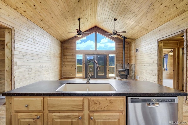 70 Elk Cir, Guffey, CO 80820 - kitchen featuring dishwasher, dark countertops, ceiling fan, light brown cabinets, and wooden walls