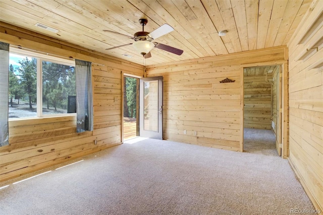 70 Elk Cir, Guffey, CO 80820 - carpeted empty room featuring wood ceiling, wood walls, and a ceiling fan