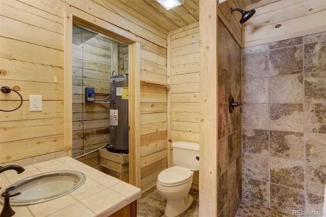 70 Elk Cir, Guffey, CO 80820 - bathroom featuring electric water heater, wood walls, a shower stall, and vanity