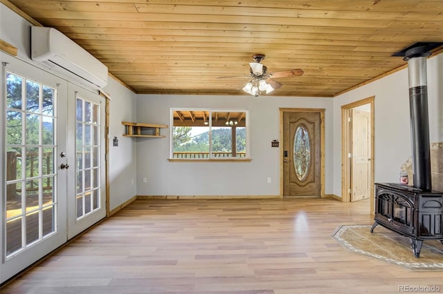 70 Elk Cir, Guffey, CO 80820 - entryway with french doors, a wood stove, wood ceiling, a wall mounted AC, and wood finished floors