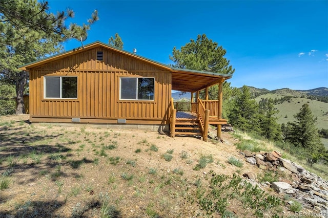 70 Elk Cir, Guffey, CO 80820 - view of front of property featuring board and batten siding, a deck with mountain view, and crawl space