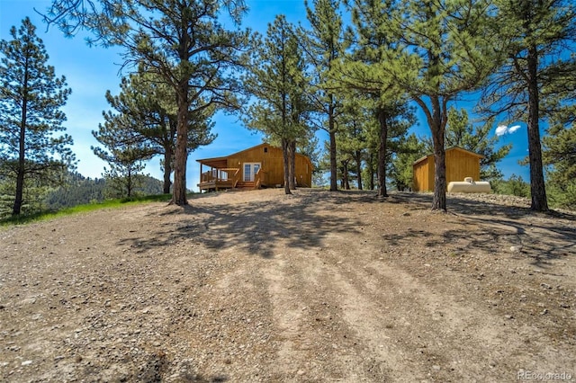70 Elk Cir, Guffey, CO 80820 - view of yard featuring a wooden deck and an outbuilding
