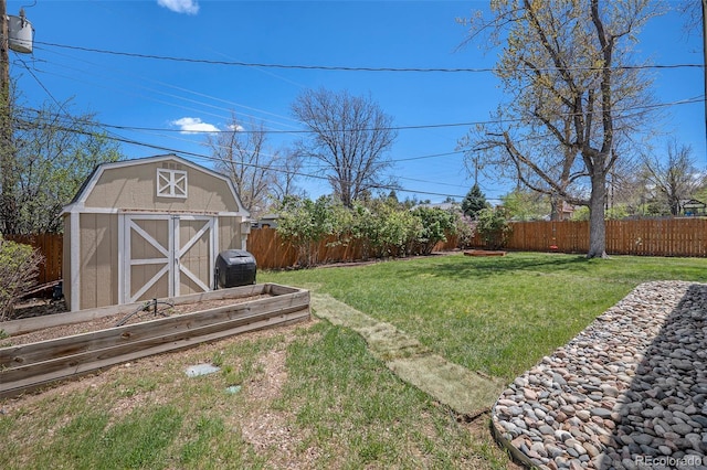 view of yard featuring a storage shed, an outbuilding, and a fenced backyard