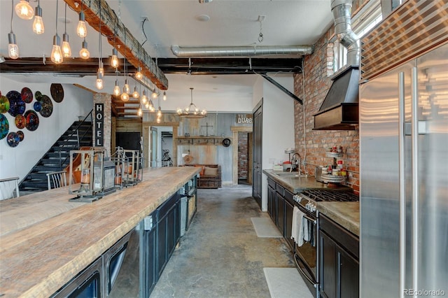 kitchen featuring stainless steel appliances, concrete floors, a sink, custom range hood, and a chandelier