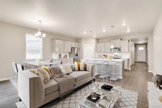1144 Ridgefield Dr, Berthoud, CO 80513 - living room featuring light wood-style floors, a chandelier, and recessed lighting