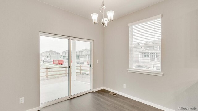 1144 Ridgefield Dr, Berthoud, CO 80513 - empty room with a chandelier and wood finished floors