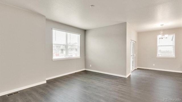 1144 Ridgefield Dr, Berthoud, CO 80513 - empty room with a chandelier and dark wood finished floors