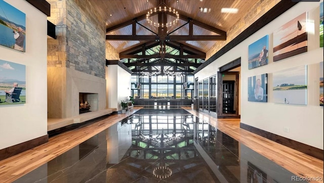1144 Ridgefield Dr, Berthoud, CO 80513 - interior space with high vaulted ceiling, a chandelier, a fireplace, and wood ceiling