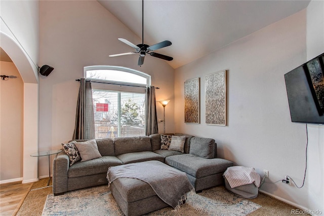 living room featuring ceiling fan and high vaulted ceiling