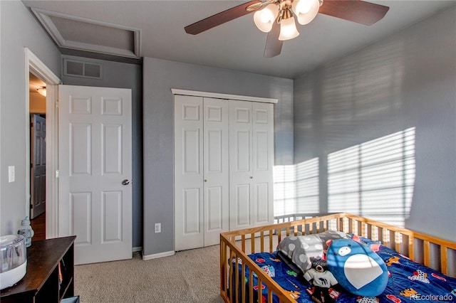 carpeted bedroom with a closet and ceiling fan