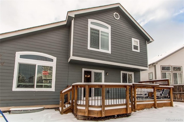 snow covered property featuring a wooden deck