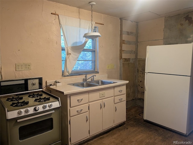 4209 Perry St, Denver, CO 80212 - kitchen with white appliances, white cabinets, light countertops, dark wood-style floors, and a textured wall