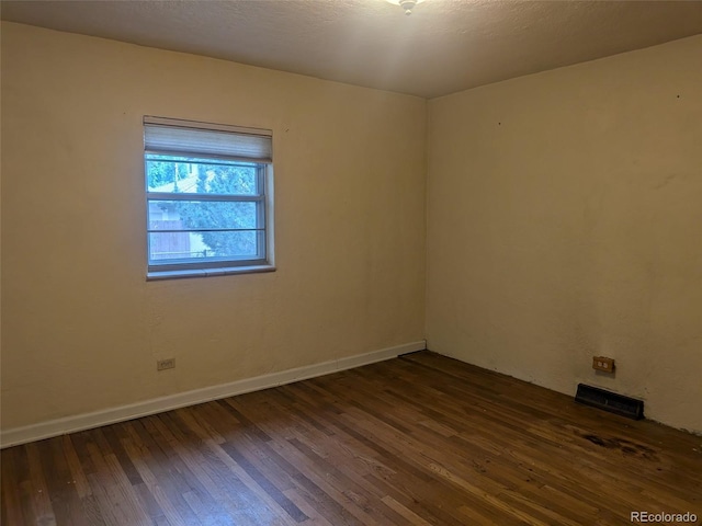 4209 Perry St, Denver, CO 80212 - empty room featuring dark wood-style floors and baseboards