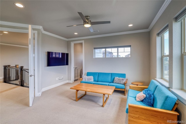 carpeted living room with ceiling fan and ornamental molding