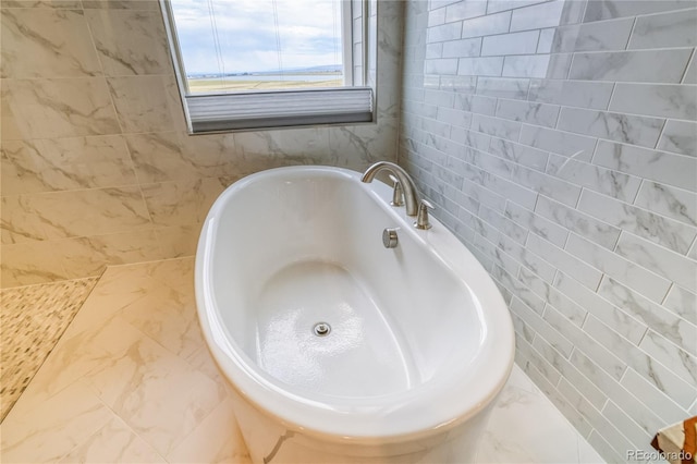 bathroom with tile walls and a bathing tub