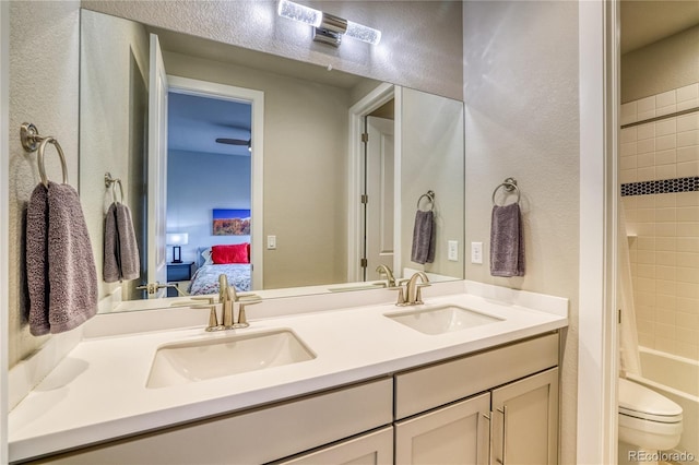 full bathroom with vanity, shower / bath combination with curtain, and toilet