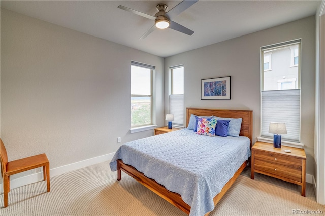 bedroom with ceiling fan and light carpet