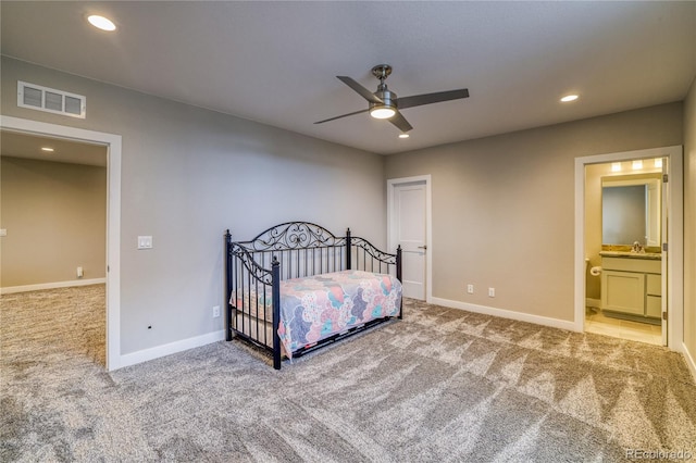 carpeted bedroom featuring connected bathroom, ceiling fan, and sink